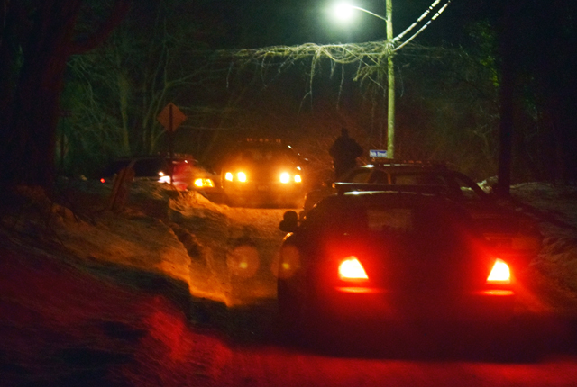 A police officer walks down Hulse Avenue between 12th and 14th streets shortly after police cleared a house where three bodies were found in Wading River. (Credit: Grant Parpan)