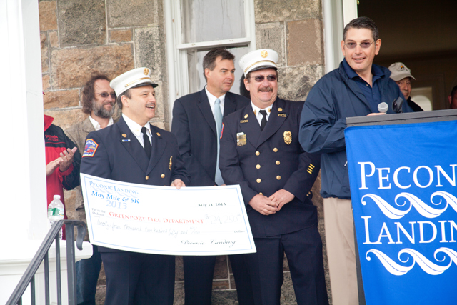Peconic Landing CEO Robert Syron (right) at a check presentation for the May Mile.