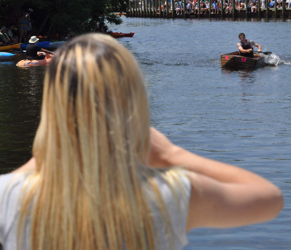 Aliyah Phelps, 15, watches  Michael Cobb, 25, of Flanders win the Riverhead Yacht Club Regatta in a boat she helped build.(Credit: Grant Parpan)