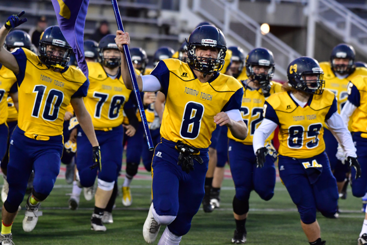 Joe Miller leads the team out with the No. 54 flag. (Credit: Robert O'Rourk)