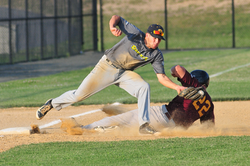 Riverhead Tomcats outfielder Andrew Plunkett slides into third as North Fork Osprey Penn Murfee tries to apply the tag. (Credit: Bill Landon)