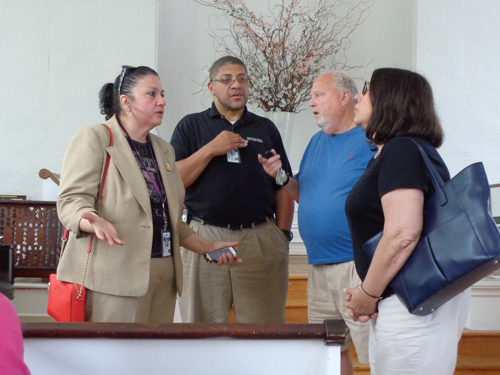 Annette D'Amato of the USPS (left) speaks with South Jamesport residents at Wednesday's meeting at the Jamesport Meeting House. (Credit: Claire Leaden)