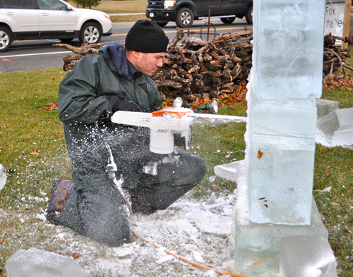 RACHEL YOUNG PHOTO | Professional ice sculptor Rich Daly, of Mastic Beach, uses a chainsaw to carve the image of Santa Claus at Sherwood House Vineyards in Jamesport Saturday afternoon.