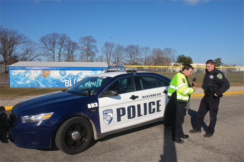 Riverhead police officer Doug Geraci (left) arrived on the scene at Riverhead High School Thursday. (Credit: Barbaraellen Koch)