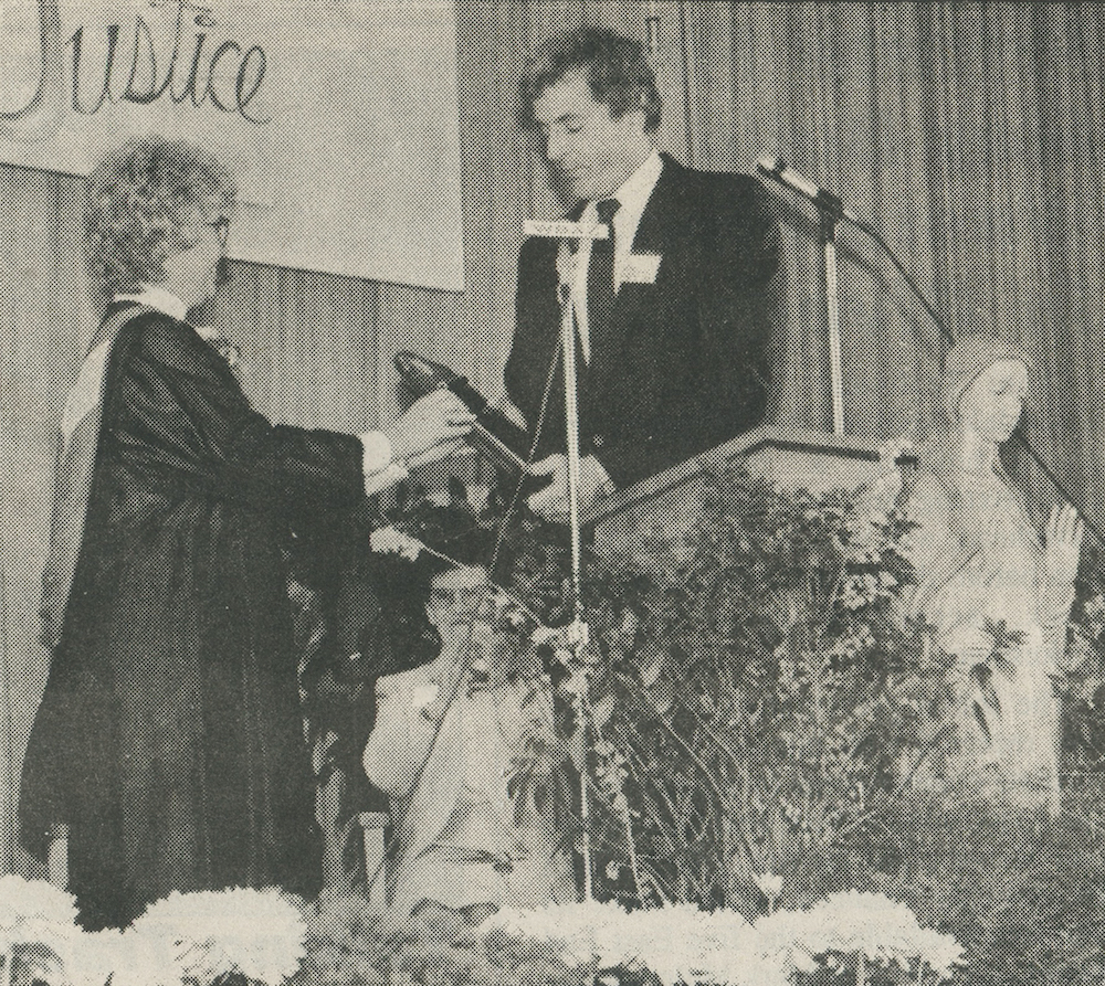 In March 1990, Mercy High School principal Sister Elaine Hanson accepted the school’s 1989 state School of Excellence award from Department of Education representative Herbert Stupp in a ceremony at the school.