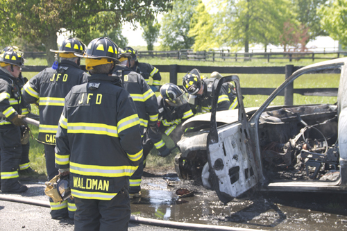 Jamesport firefighters put out a fire in a Dodge pickup truck around noon Tuesday on Manor Lane in Jamesport. (Credit: Grant Parpan)
