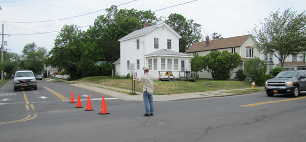 Traffic from Wiggins Street (left) is directed into the ferry line while those trying to join the line from Third Street are told to turn around and go back to Front Street unless there’s no back up of vehicles on Wiggins. (Credit: Julie Lane)