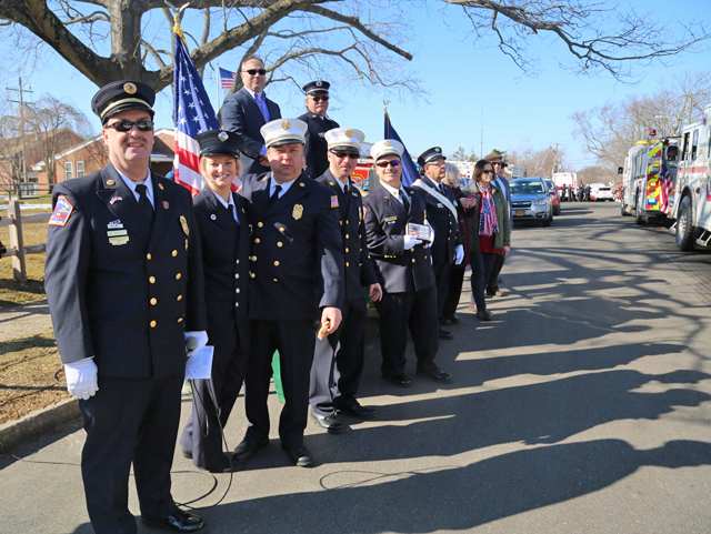 Greenport Fire Department members and village trustees welcoming marchers at the end of the parade. (Credit: Krysten Massa)