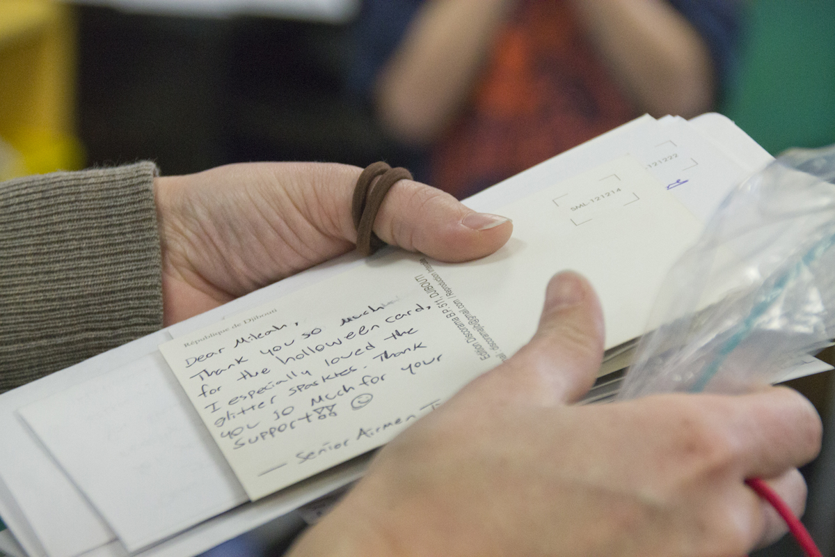 A teacher holds a stack of letters from military volunteers after Lt. Col. Shawn Fitzgerald's presentation in a Cutchogue classroom Friday afternoon. (Credit: Paul Squire) 