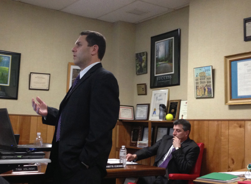 PAUL SQUIRE PHOTO | Elementary school principal Joseph Tsaveras (left) presents how students are preparing for state assessments Wednesday night.