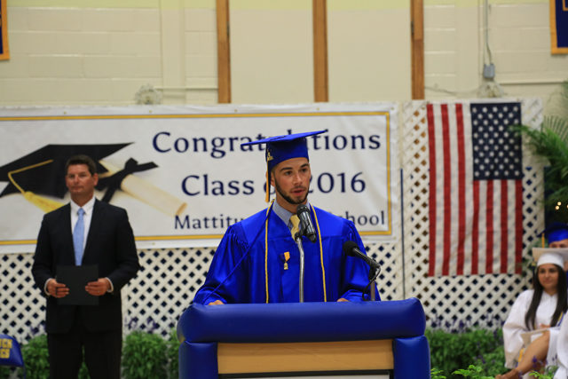 Class president Greg Sheryll leads students in the turning of the tassels. (Credit: Krysten Massa) 