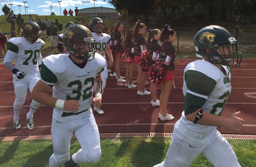 The Bishop McGann-Mercy Monarchs make their entrance onto the field before the kickoff of Saturday's game at Center Moriches High School. (Credit: Bob Liepa)