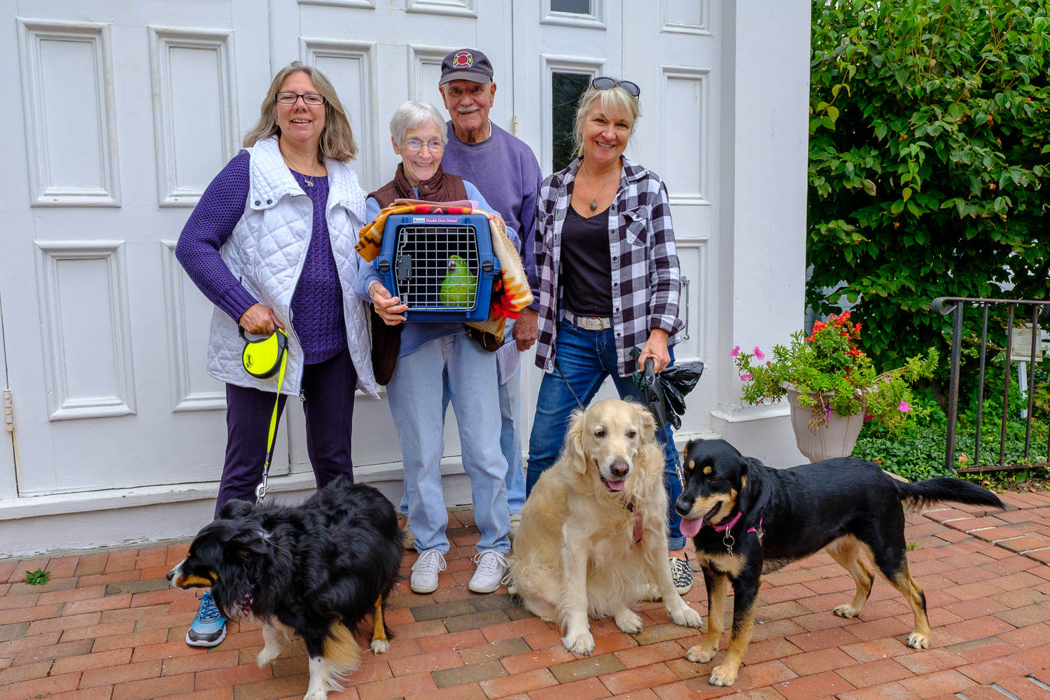 Hawkeye (Parrot), Bailey, Glory and Ranger with their owners Betty and George Capon of Greenport, Holly Weingart  of East Marion and Sharon Bogden  of Greenport. (Credit: Jeremy Garretson)