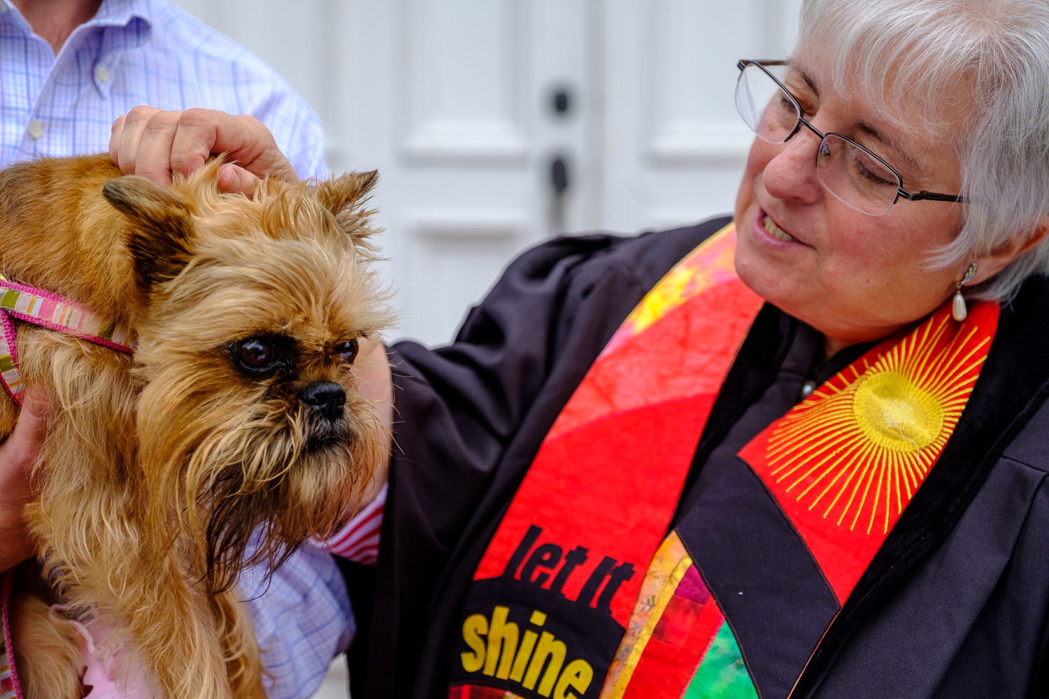 Rev. Dr. Ann Van Cleef blesses Gretchen, a griffon. (Credit: Jeremy Garretson)