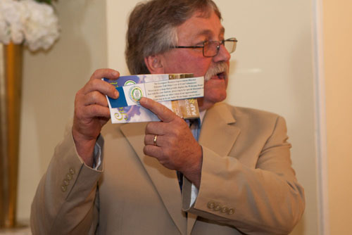 Mayor Hubbard shows off a special pin given to crew of the ships.