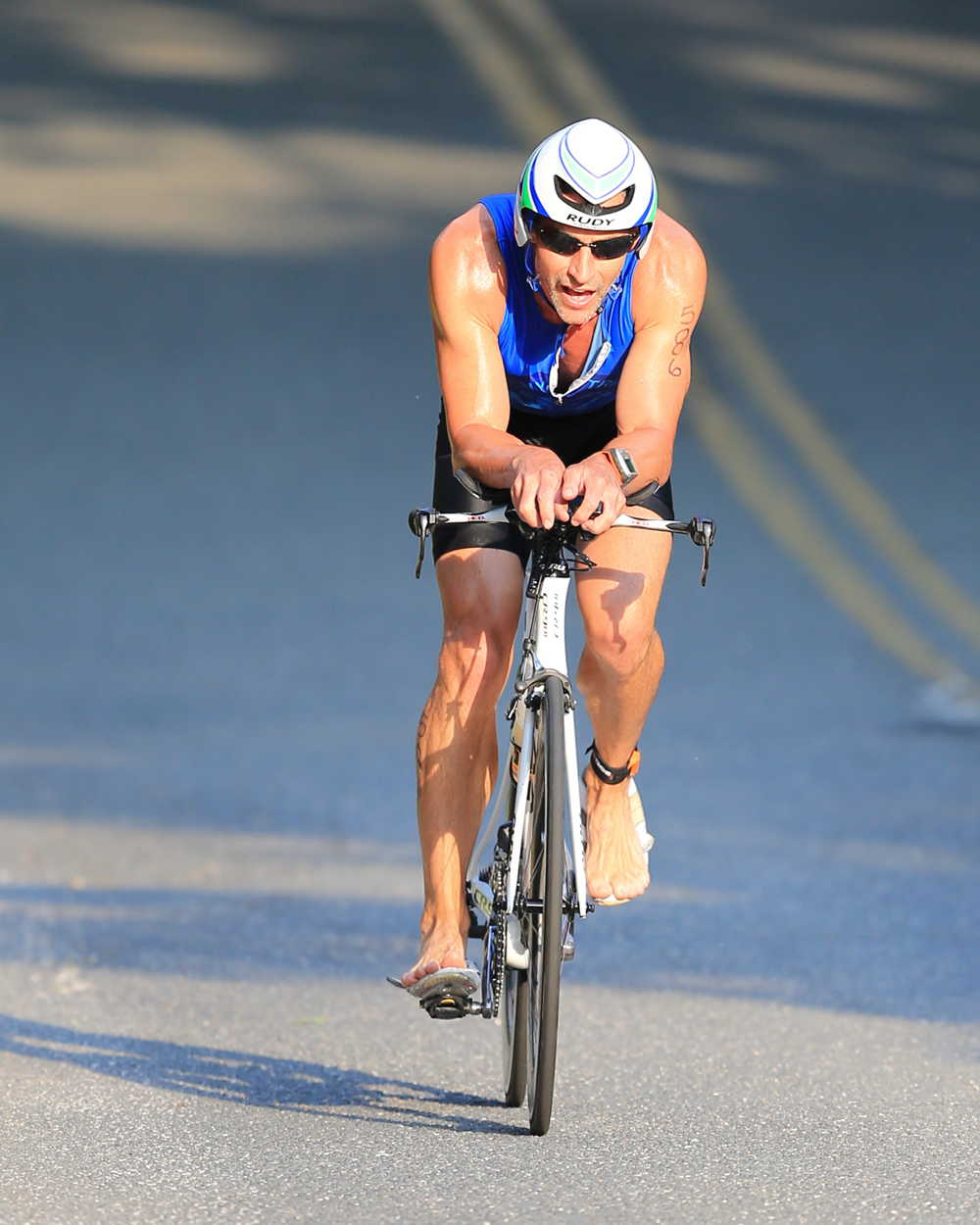 A barefoot Adrian Mackay of NYC placed first in the Bicycle leg of the Mighty North Fork Triathlon. (Credit: Daniel De Mato)