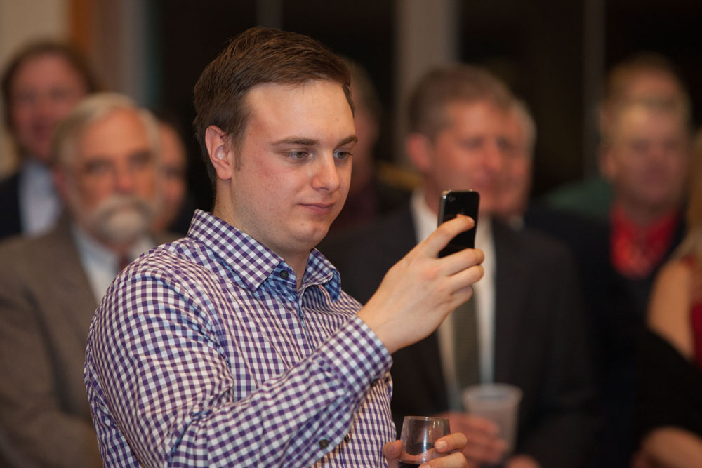 Joe's son Jonathan films his father's speech. (Credit: Katharine Schroeder)