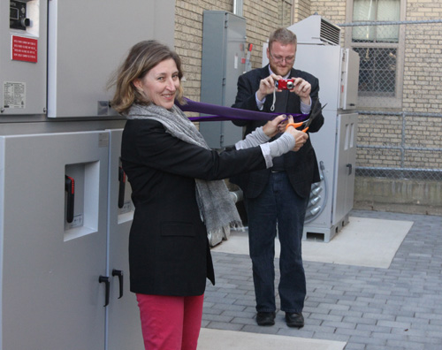 JENNIFER GUSTAVSON PHOTO | Greenport school board president Heather Wolf cuts the 'Porter Purple' ribbon Friday unveiling the district's new solar-powered system.