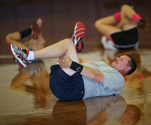 Mike Gunther, leading Greenport/Southold's players in a stretching exercise, has begun his second stint as coach of the Clippers. (Credit: Garret Meade)