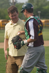 GARRET MEADE PHOTO | The Hamptons Collegiate Baseball League president, Brett Mauser, was handed the ball by Riverhead Tomcats catcher Jason Gordon after throwing the ceremonial first pitch.