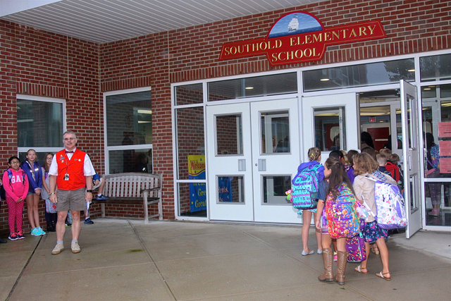 Fourth grade teacher Skip Munisteri waits for his students outside the school.