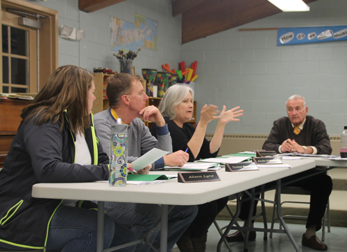 PAUL SQUIRE PHOTO | Board member Linda Goldsmith (second from right) discusses the veterans tax exemption with the rest of the board at Tuesday night's public hearing.