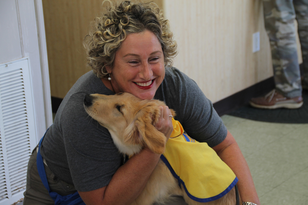 Ms. Dellaquila with Wellington, an 18-week-old puppy. (Credit: Paul Squire)