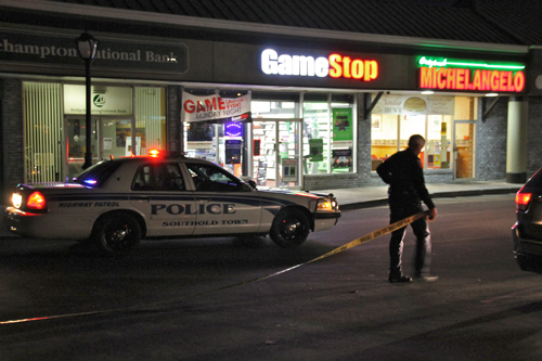 PAUL SQUIRE PHOTO | A Southold police officer ropes off the scene of an armed robbery at the GameStop in Mattituck Tuesday night.