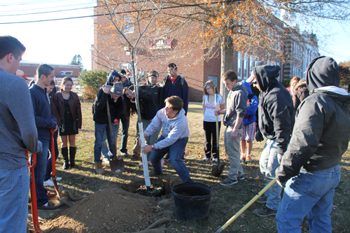 PAUL SQUIRE PHOTO | Southold students plant a redbud tree in honor of Ronan Guyer, the Southold teen who suffered a heart attack and died last year.