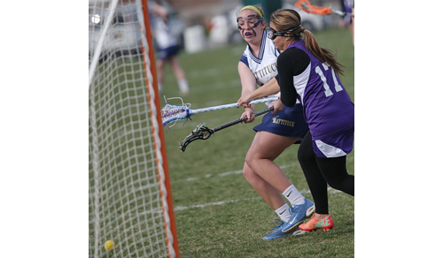 Mattituck/Greenport/Southold's Molly Kowalski gets off a shot despite the efforts of Hampton Bays' Paula Cardenas. (Credit: Garret Meade)