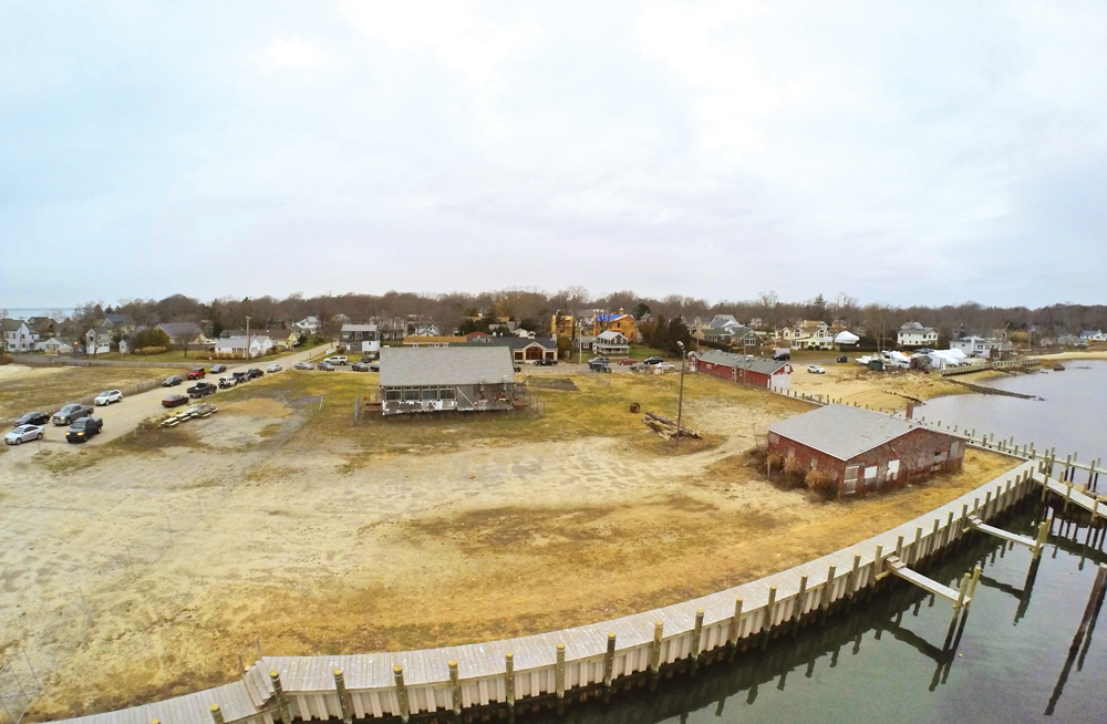 Despite its age — well over 100 years old — and precarious locations near the bay in New Suffolk, the Galley Ho building (center) managed to survive the 1938 hurricane, the 'Perfect Storm' and, most recently, superstorm Sandy, among other weather events. It will soon be renovated, raised and moved for a fifth time — about 30 feet closer to the water — as part of a waterfront development project. (Credit: Andrew Lepre)