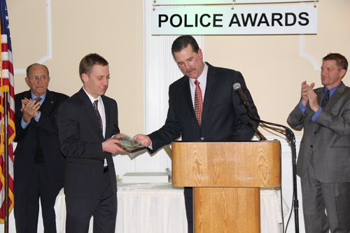 CARRIE MILLER PHOTO  |  Southold police officer Jacob Bogdoen receives an Officer of the Year award, which was presented by chief Martin Flatley.