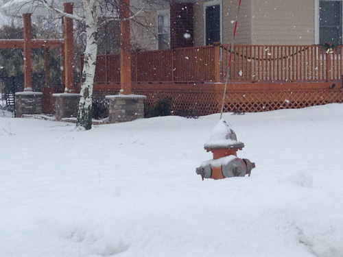 PAUL SQUIRE PHOTO | A fire hydrant in Calverton half-buried in the snow Tuesday morning. 