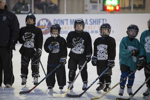 KATHARINE SCHROEDER | The Greenport Pirates take to the ice at Mitchell Park for the National Anthem Saturday night.