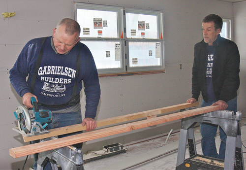 Carpenter Rem Stabas (left) and contractor Tom Gabrielsen working in the kitchen of a Peconic home where they did a complete remodel, gutted all the walls and built two additions. (Credit: Barbaraellen Koch)