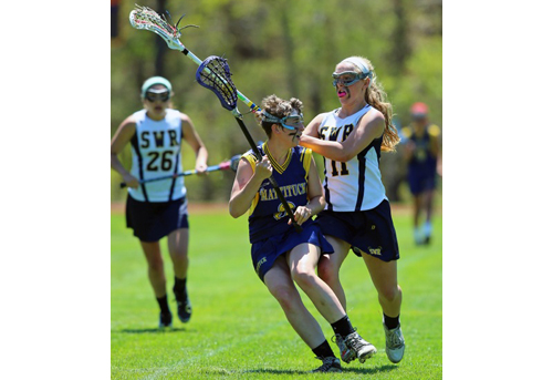 Shoreham-Wading River's Logan Hoffmann, right, pressures Mattituck/Greenport/Southold's Justine Kundmueller in the second half. (Credit: Daniel De Mato)
