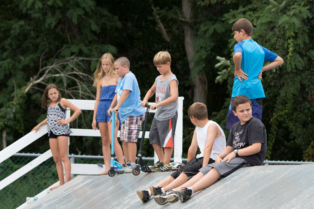 A group of youngsters survey the course before beginning to skate.