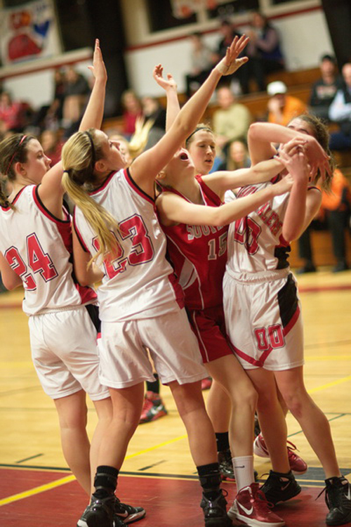 GARRET MEADE PHOTO | Carley Staples of Southold is swarmed by Pierson/Bridgehampton's Bridget Canavan (24), Emily Hinz (23) and Meg Evjen (00).