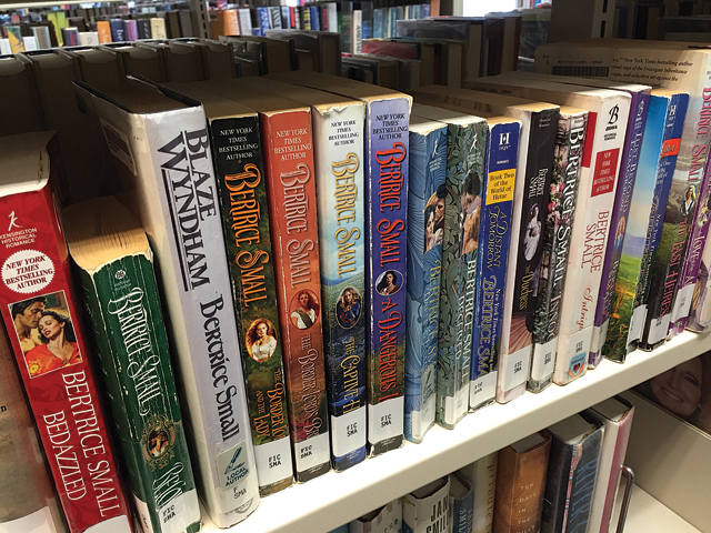 Local author Bertrice Small's books occupy two shelves in the adult fiction section of Mattituck-Laurel Library. (Credit: Rachel Young)