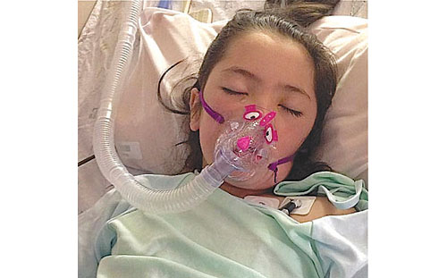 DINA REILLY COURTESY PHOTO | Maya Reilly in her hospital bed at Stony Brook University Medical Center.