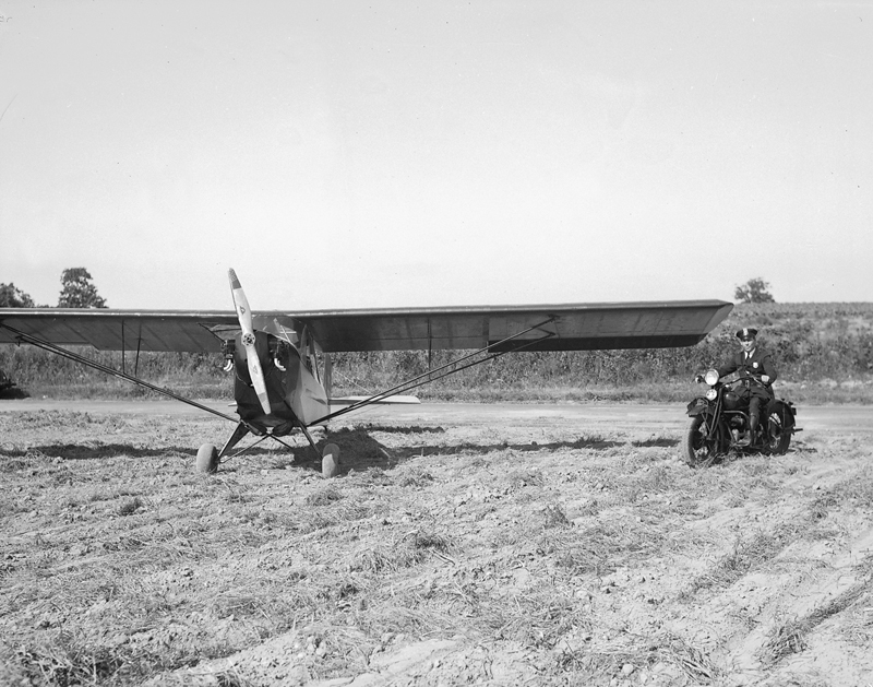 This 1930s photo shows police officer Pat Kelly with his motorcycle and private plane. Mr. Richter said Mr. Kelly would use the plane for police purposes when they needed an eye in the sky.