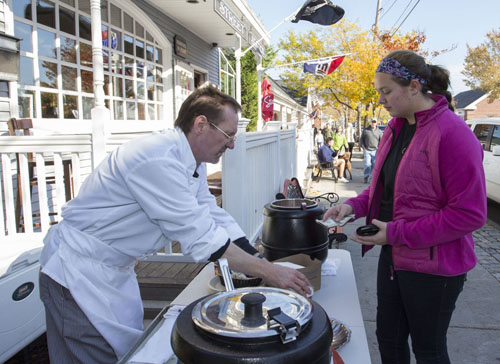 KATHARINE SCHROEDER PHOTO | Scott Oliver serves chowder to Keri Ann Mahoney of Shelter Island outside Front Street Station.