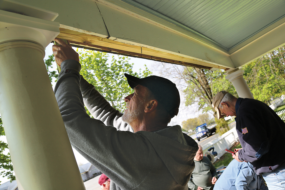 Gary Richau helps install a new facade on the historic Hallock homestead at Hallockville Museum Farm last Tuesday morning. Mr. Richau and the 12 other crew members take on carpentry and woodworking projects for nonprofit groups across the North Fork. (Credit: Paul Squire)