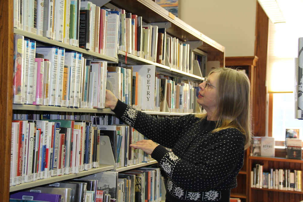 Poppy Johnson has spent the past 18 months reorganizing books by topic. (Credit: Carrie Miller)