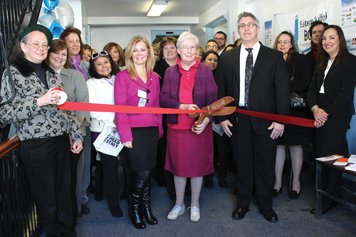BOCES COURTESY PHOTO | Holding the big scissors is Sister Margaret Smyth of North Fork Spanish Apostolate at 220 Roanoke Ave. Riverhead. 