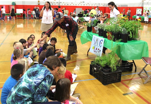 Students get a lesson on planting from Sang Lee Farms.