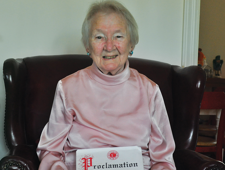In 1999, when she turned 85, the town honored Mary Tuthill for her work establishing a nutrition center for senior citizens. Here, as she nears her 100th birthday, she holds the proclamation she was given by town officials.
